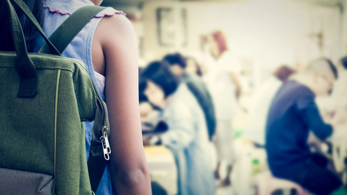 Child walking into her classroom