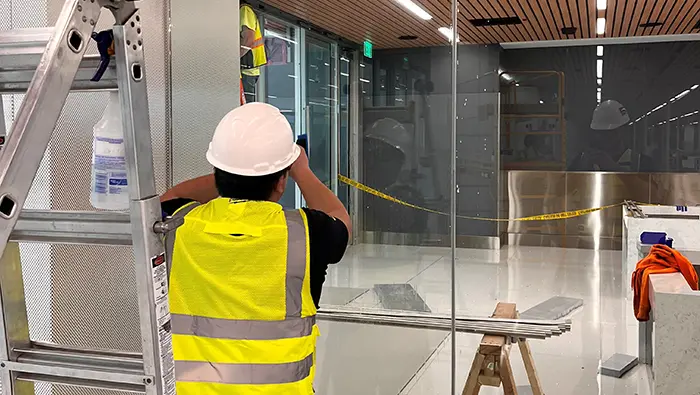 ICU contracted installer installing Clear Armor laminate on glass wall